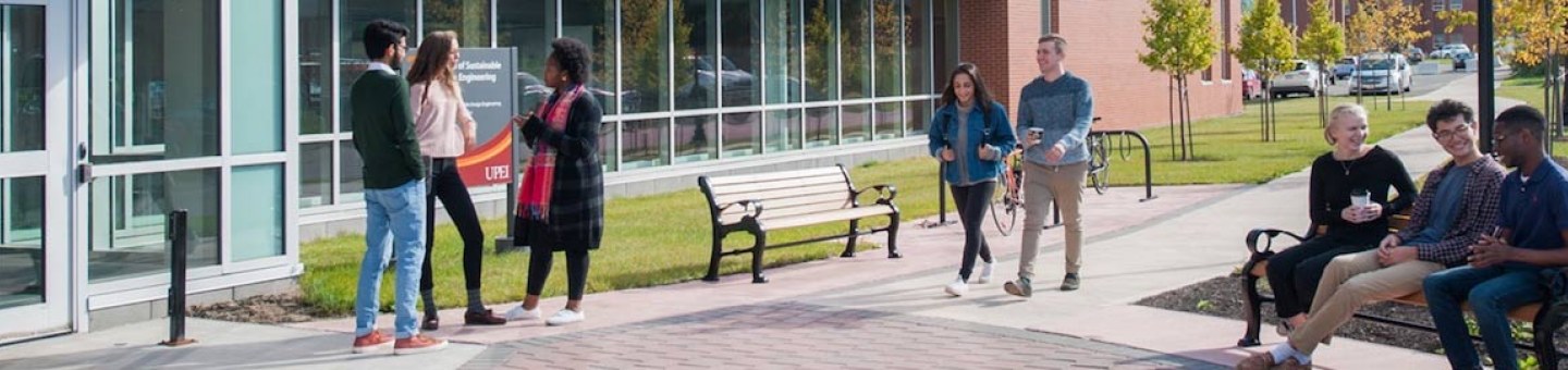 student in front of the faculty of sustainable design engineering building