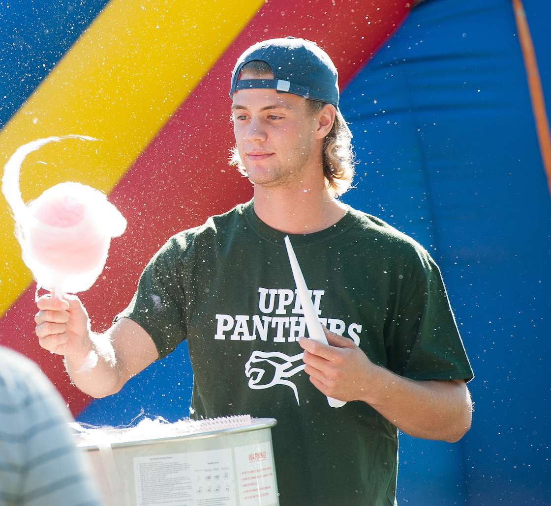 A man spins cotton candy at the campus carnival