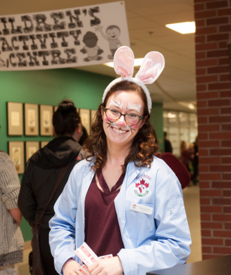 a veterinary student with her face painted like a rabbit