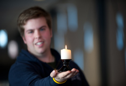 A student holds a candle