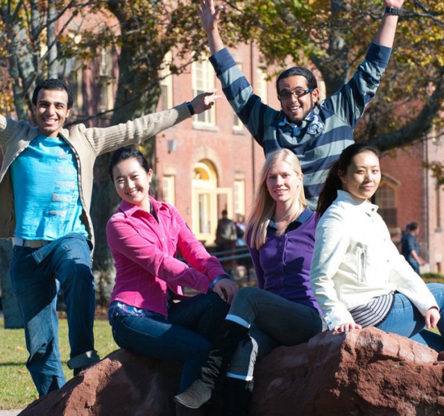international students sitting in front of the university quad